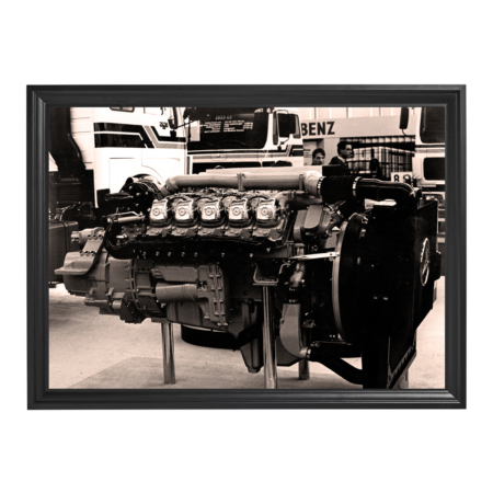 Framed sepia photo of a vintage Mercedes-Benz engine on display.