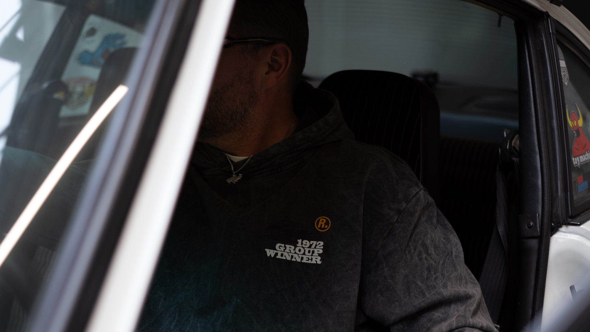 Racing Relics hoodie worn inside a classic Porsche